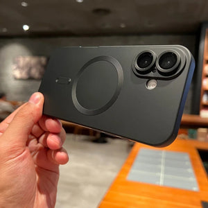 Person holding a black phone case with a blurred indoor background