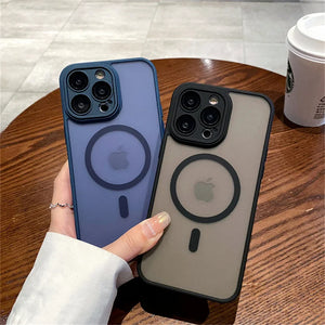 Two Matte translucent magnetic iPhone case with camera lens protection and MagSafe held by a hand on a wooden table.