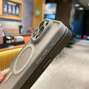 Smartphone with a case held by a hand in an indoor setting