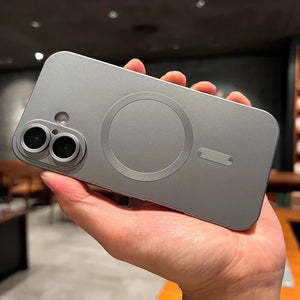 Person holding a gray phone case with a blurred indoor background