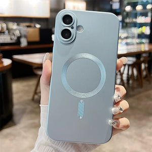 Person holding a phone with a metallic back design in a blurred indoor setting