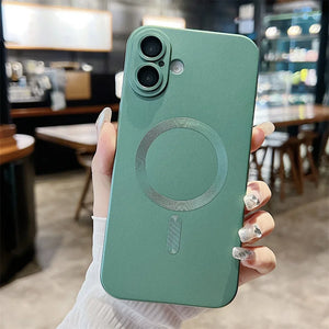 Green phone case with a magnetic charging pad held in a hand, blurred cafe background
