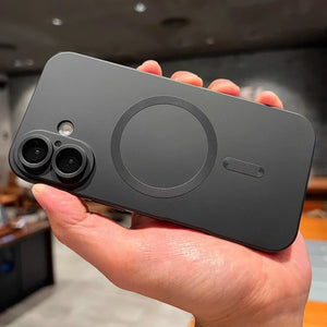 Person holding a black smartphone with a blurred indoor background