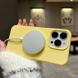 Yellow iphone case with a magnetic stripe held by a person indoors.