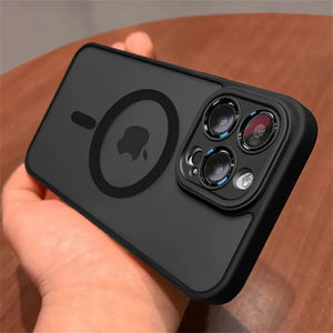 Black Matte translucent magnetic iPhone case with camera lens protection and MagSafe held by a hand on a wooden surface
