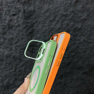 Two iphone cases, one green and one orange, held against a dark textured background.