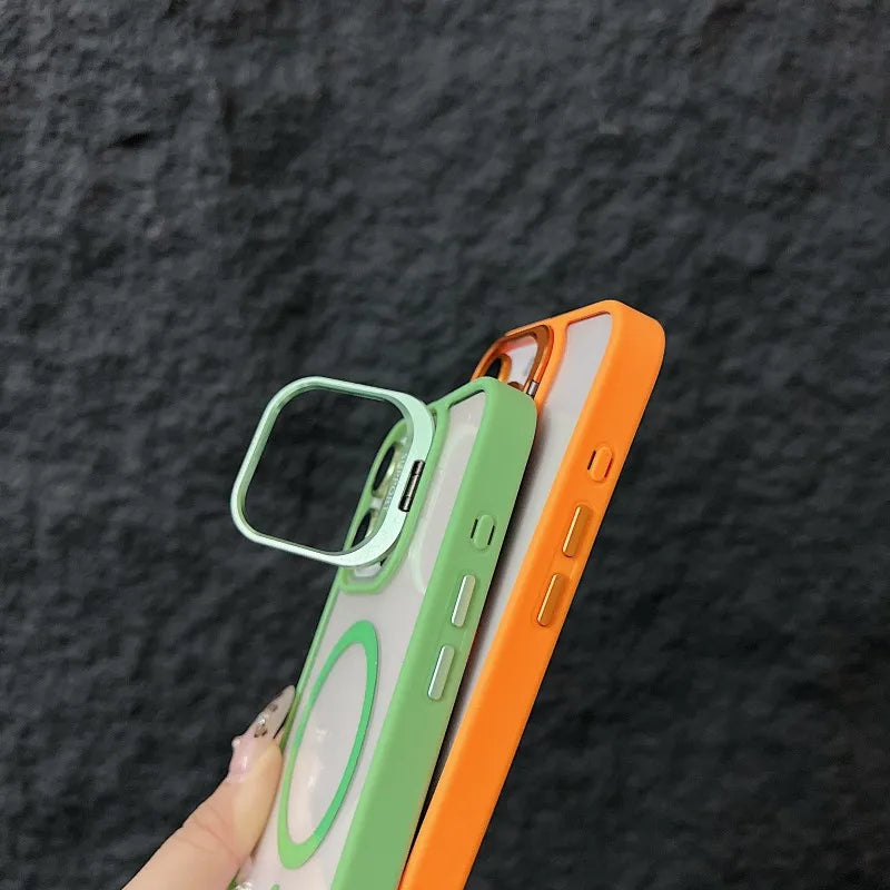 Two iphone cases, one green and one orange, held against a dark textured background.