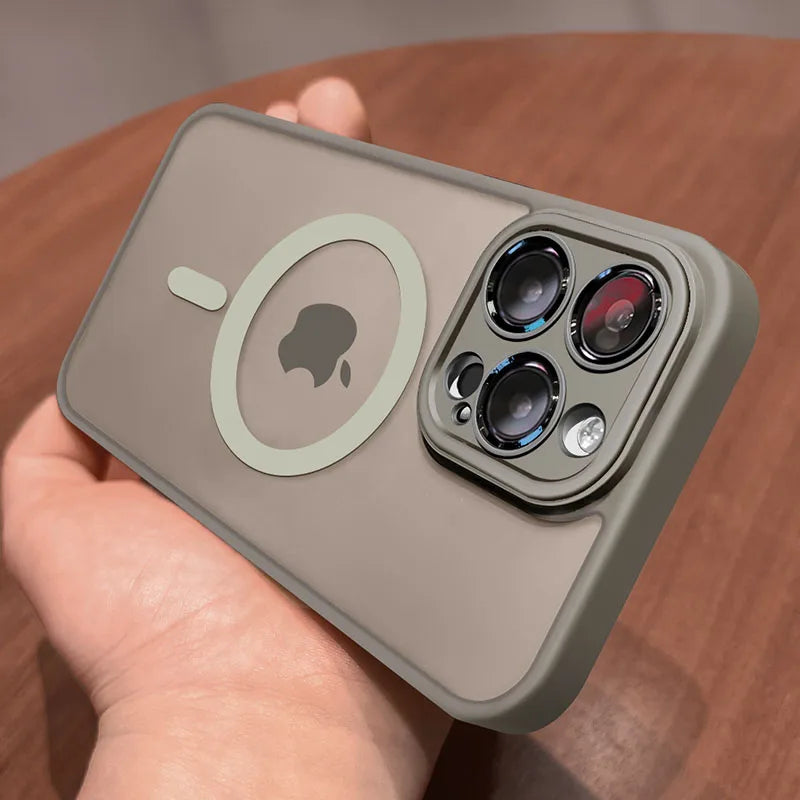 Hand holding a Matte magnetic iPhone case compatible with Magsafe wireless charging and camera details on a wooden surface