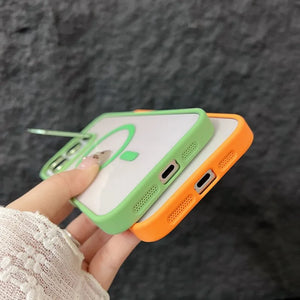 Two iphone cases, one green and one orange, held by a hand against a dark textured background.